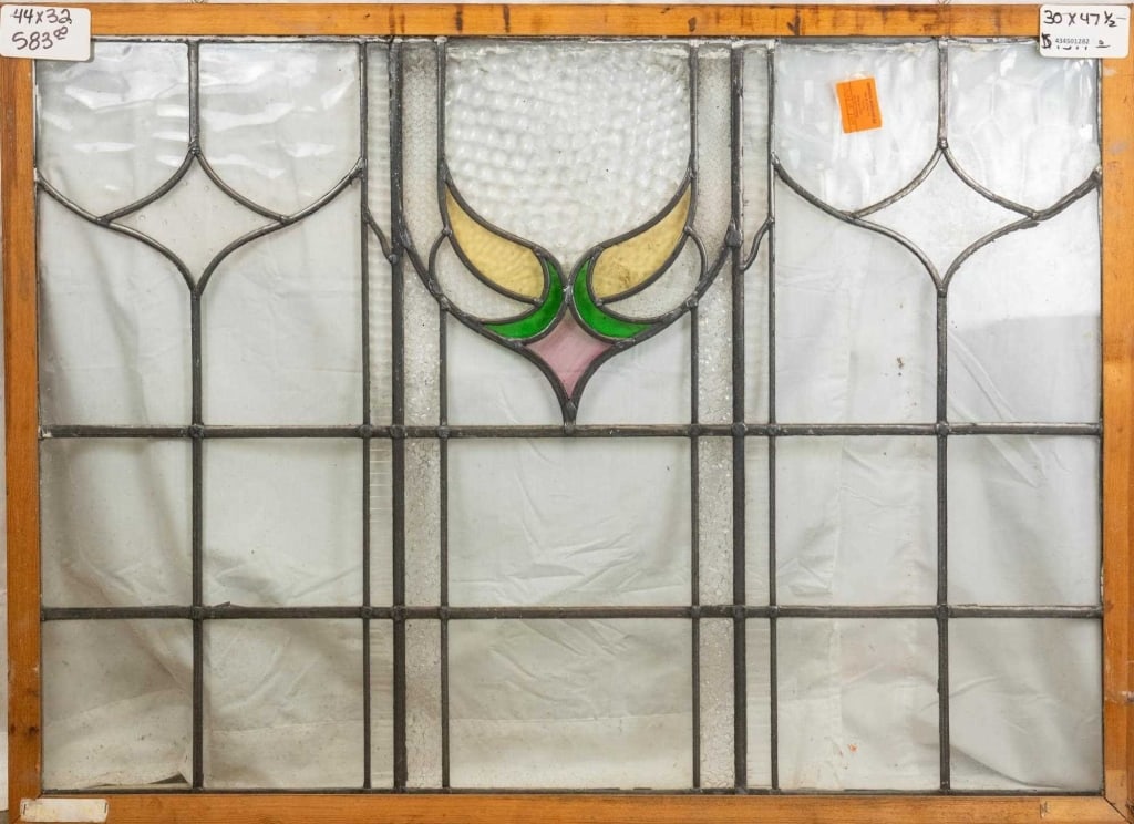 FRENCH ART NOUVEAU STAINED GLASS PANEL: French Art Nouveau stained glass panel with a floral motif medallion and textured colorless leaded glass panels. Approximate dimensions: h. 30", w. 47.5" Disclaimer: This is an online court ordered ba