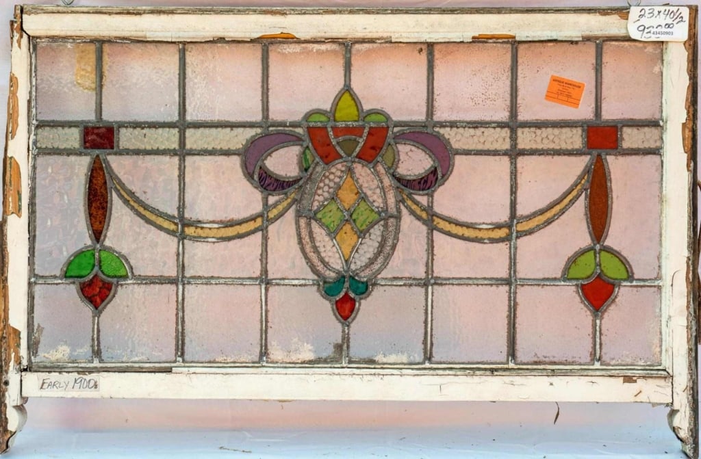 FRENCH ART NOUVEAU STAINED GLASS PANEL: French Art Nouveau stained glass panel with floral and ribbon stained glass motifs. Approximate dimensions: h. 23", w. 40.5" Disclaimer: This is an online court ordered bankruptcy sale. Participating
