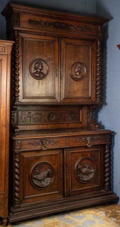 FRENCH RENAISSANCE REVIVAL HUNTING CABINET: French Renaissance Revival hunting cabinet with figural carving accents, carved rosettes, barley twist column details, and deeply carved pheasant motifs. Approximate dimensions: h. 100.5", w. 55", d. 