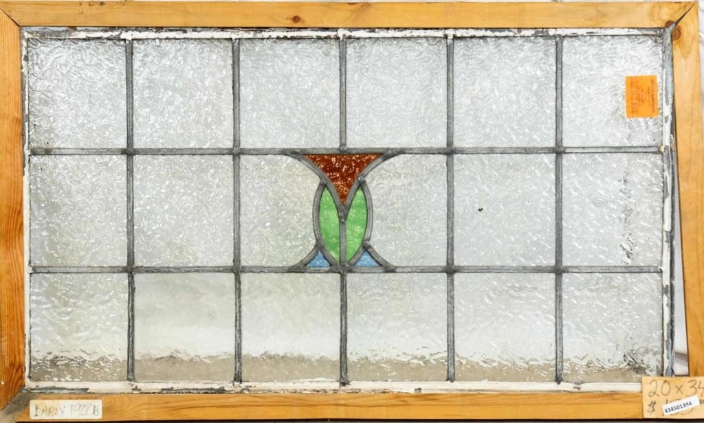 CONTINENTAL STAINED GLASS PANEL: Continental stained glass panel with red, blue, and green stained glass accents. Approximate dimensions: h. 20", w. 34" Disclaimer: This is an online court ordered bankruptcy sale. Participating bidde