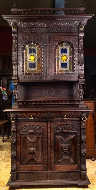 FRENCH RENAISSANCE REVIVAL STAINED GLASS BUFFET: French Renaissance Revival stained glass buffet with carved backsplash, figural supports, lion head and brass ring decorations. Approximate dimensions: h. 101", w. 45", d. 19.5" Disclaimer: This is an