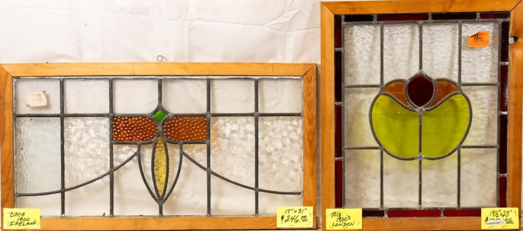 TWO CONTINENTAL STAINED GLASS PANELS: Two Continental stained glass panels, each with amber, chartreuse, green, and canary yellow accents. Approximate dimensions: h. 17", w. 31" Disclaimer: This is an online court ordered bankruptcy sale.