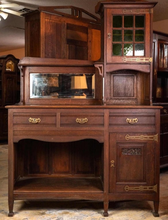 FRENCH ART NOUVEAU MIRRORED BACK BUFFET: French Art Nouveau mirrored back buffet with carved inset panels, emerald green jeweled glass, and beveled mirror backsplash. Approximate dimensions: h. 83", w. 55", d. 22" Disclaimer: This is an onli