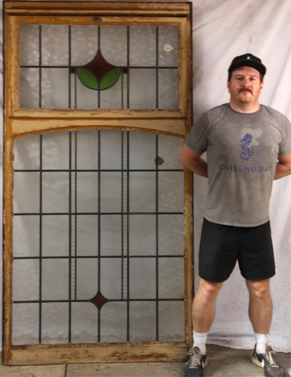 ANTIQUE CONTINENTAL STAINED GLASS PANEL: Antique Continental stained glass panel with green and red medallion. Approximate dimensions: h. 79", w. 41.5" Disclaimer: This is an online court ordered bankruptcy sale. Participating bidders must h