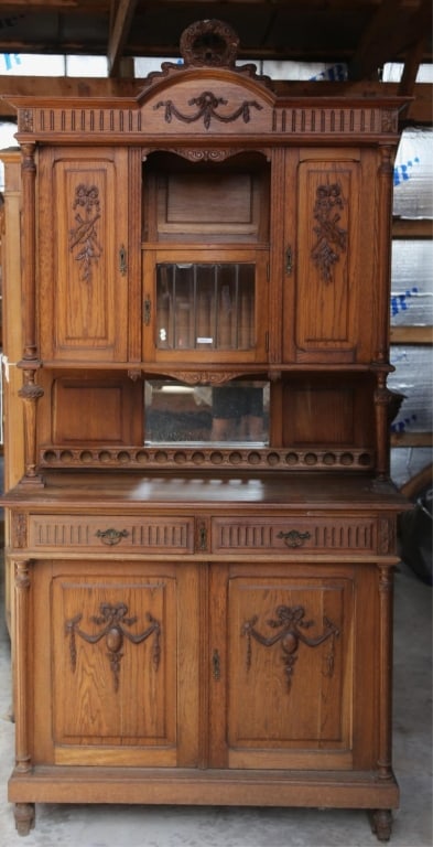 FRENCH ART NOUVEAU VITRINE BUFFET: French Art Nouveau vitrine buffet with a beveled mirror backsplash, beveled glass cabinet, carved supports and gallery, carved appliqués, and a wreath and garland pediment. Approximate dimensions: h.