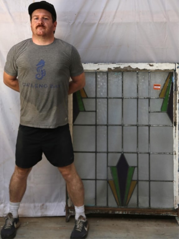 ENGLISH ART DECO STAINED GLASS PANEL: English Art Deco stained glass panel with amber, green, and yellow stained glass geometric elements. Approximate dimensions: h. 48", w. 35" Disclaimer: This is an online court ordered bankruptcy sale.