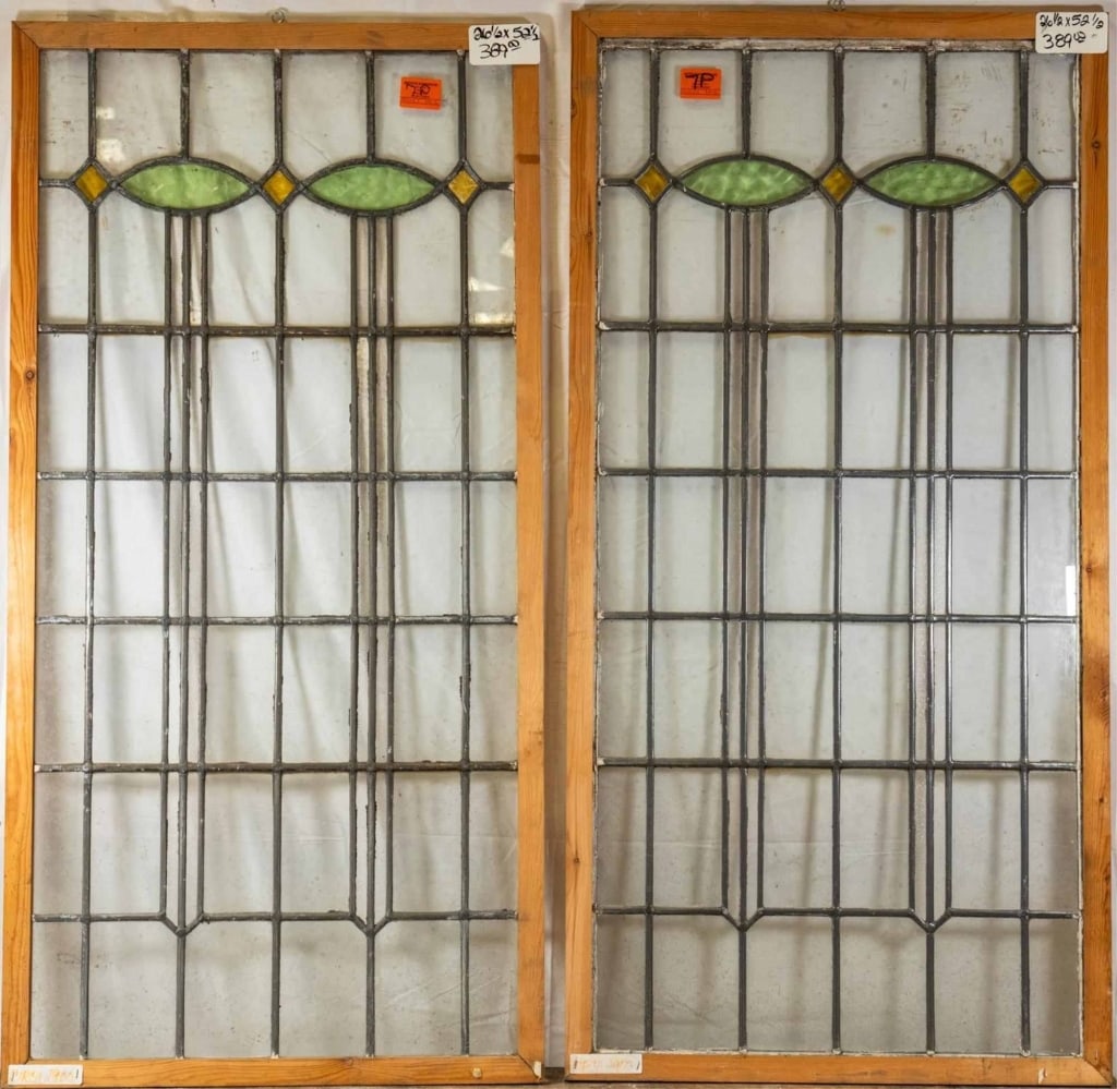 PAIR OF ENGLISH STAINED GLASS PANEL: Pair of English stained glass panels with green and yellow accents. Approximate dimensions: h. 52.5", w. 26.5" Disclaimer: This is an online court ordered bankruptcy sale. Participating bidders must h