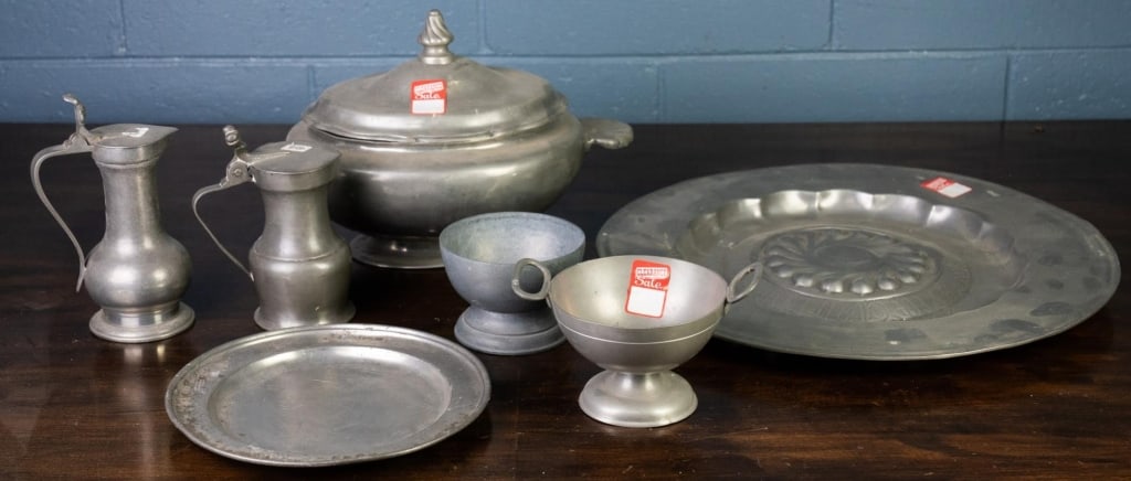 7 PEWTER TABLE ARTICLES: 7 pewter table articles, including soup tureen, wine jugs, serving bowls, and platters. Disclaimer: This is an online court ordered bankruptcy sale. Participating bidders must have a credit card on fi