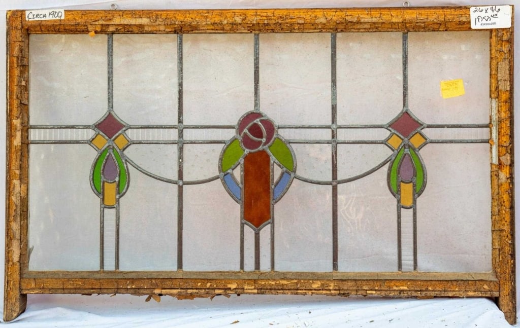 FRENCH ART NOUVEAU STAINED GLASS PANEL: French Art Nouveau stained glass panel with a central floral medallion and symmetrical abstract multicolored accents on the sides. Approximate dimensions: h. 26", w. 46" Disclaimer: This is an online