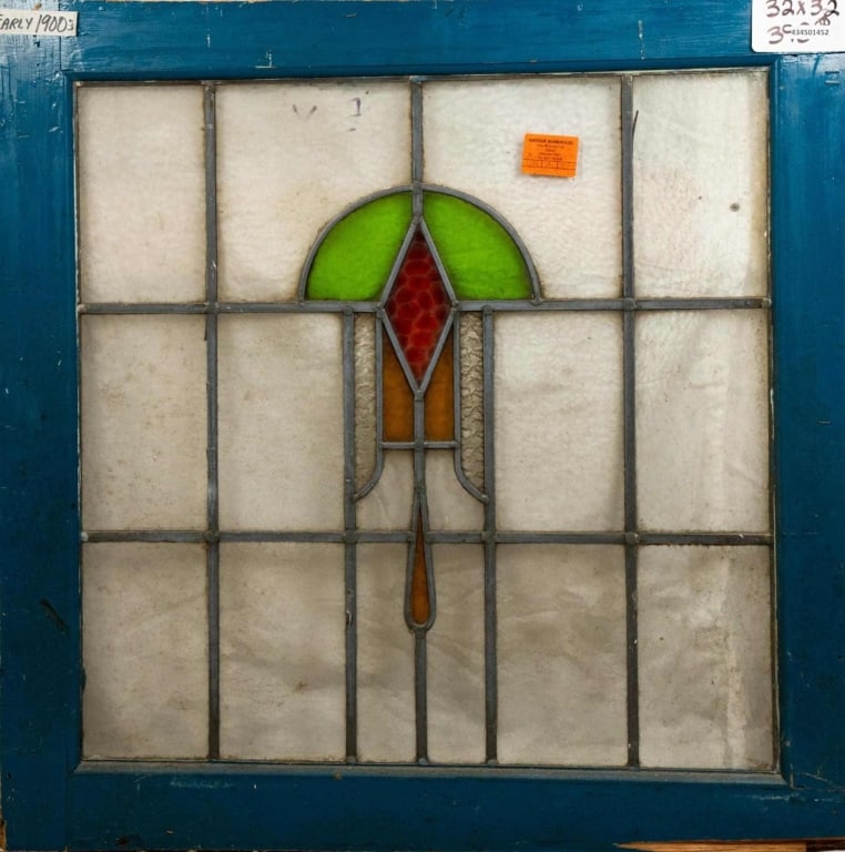 FRENCH ART DECO STAINED GLASS PANEL: French Art Deco stained glass panel with a geometric medallion in green, red, and amber. Approximate dimensions: h. 32", w. 32" Disclaimer: This is an online court ordered bankruptcy sale. Participati