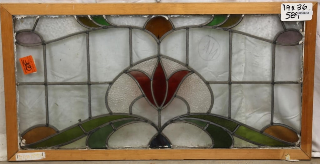 FRENCH ART NOUVEAU STAINED GLASS PANEL: French Art Nouveau stained glass panel with red flower medallion, wispy glass petals, and green, amber, and purple accents. Approximate dimensions: h. 19", w. 36" Disclaimer: This is an online court o