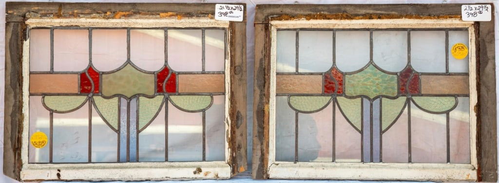 PAIR OF FRENCH STAINED GLASS PANELS: Pair of French stained glass panels with shield-shaped medallions and textured green glass accents. Approximate dimensions: h. 21.5", w. 29.5" Disclaimer: This is an online court ordered bankruptcy sa