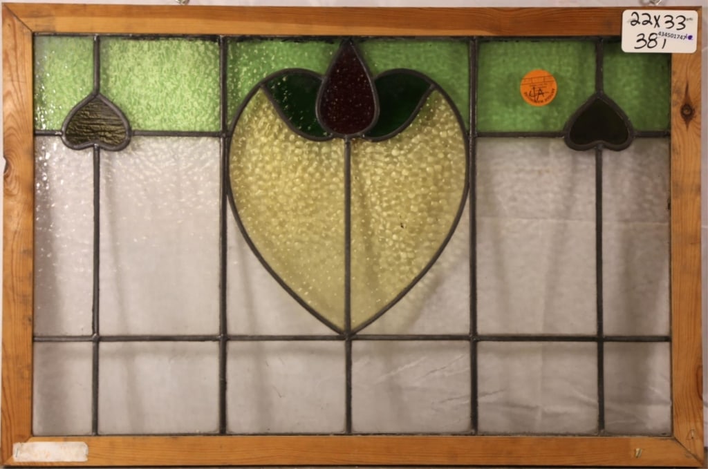 CONTINENTAL ART NOUVEAU STAINED GLASS PANEL: Continental Art Nouveau stained glass panel with heart-shaped floral medallion and red heart accent detail. Approximate dimensions: h. 22", w. 33" Disclaimer: This is an online court ordered bankruptc