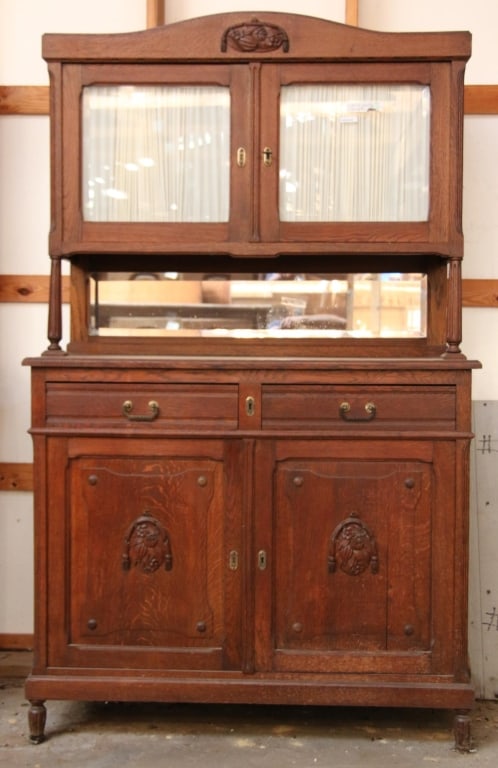 FRENCH ART NOUVEAU VITRINE CABINET: French Art Nouveau vitrine cabinet with beveled mirror backsplash, inset carved panels, and wood appliques. Approximate dimensions: h. 77", w. 47", d. 20.5" Disclaimer: This is an online court ordered