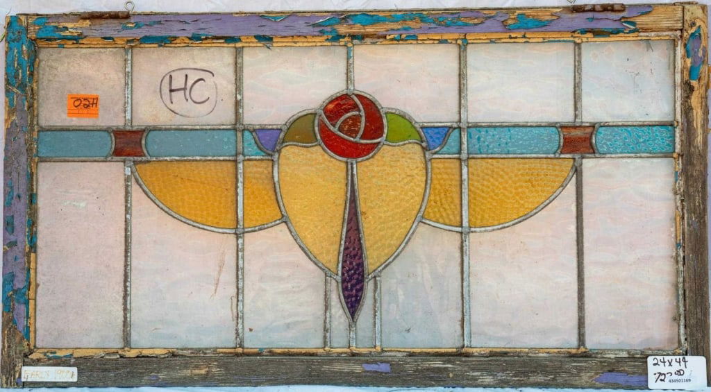 FRENCH ART NOUVEAU STAINED GLASS PANEL: French Art Nouveau stained glass panel with a rose floral medallion and amber textured glass accents. Approximate dimensions: h. 24", w. 44" Disclaimer: This is an online court ordered bankruptcy sale