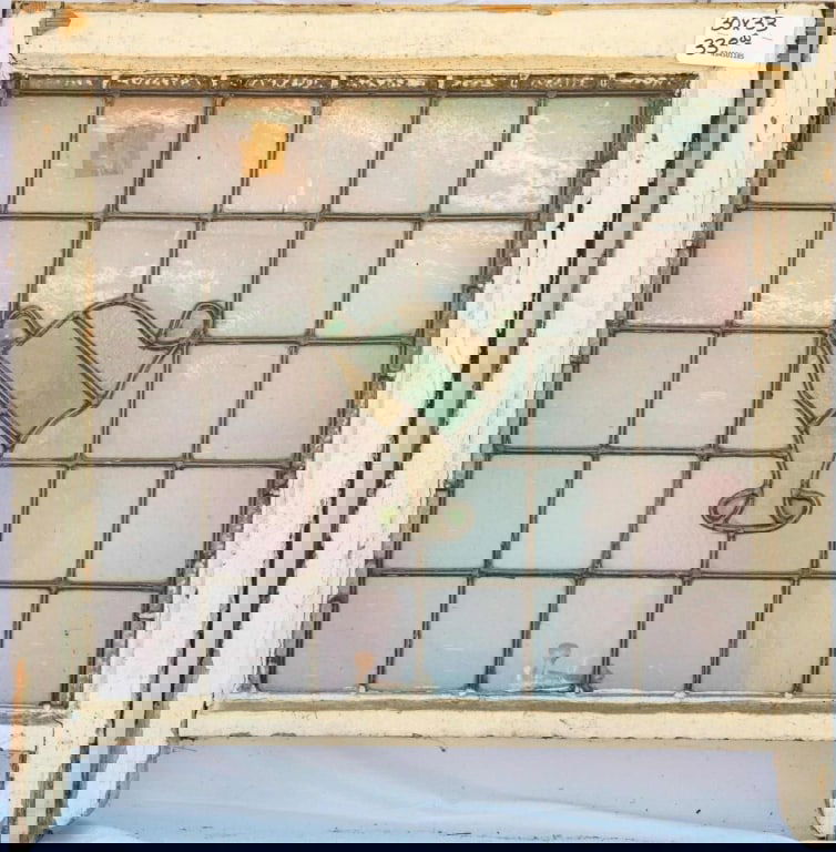 IRISH STAINED GLASS PANEL: Irish stained glass panel with a goblet-shaped central element and green leaded glass panels. Approximate dimensions: h. 33", w. 30" Disclaimer: This is an online court ordered bankruptcy sale. Partic