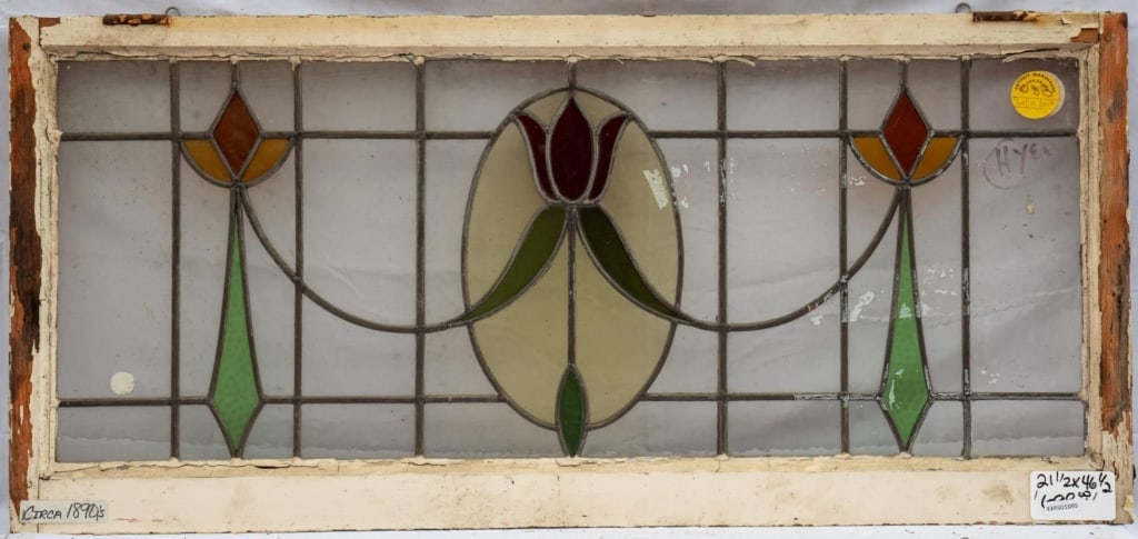 FRENCH ART NOUVEAU STAINED GLASS PANEL: French Art Nouveau stained glass panel with tulip and ribbon details. Approximate dimensions: h. 29.5", w. 46.5" Disclaimer: This is an online court ordered bankruptcy sale. Participating bidders must