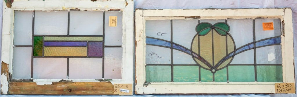 TWO CONTINENTAL STAINED GLASS PANELS: Two Continental stained glass panels with floral and geometric motifs. Approximate dimensions: h. 16", w. 30" Disclaimer: This is an online court ordered bankruptcy sale. Participating bidders must ha