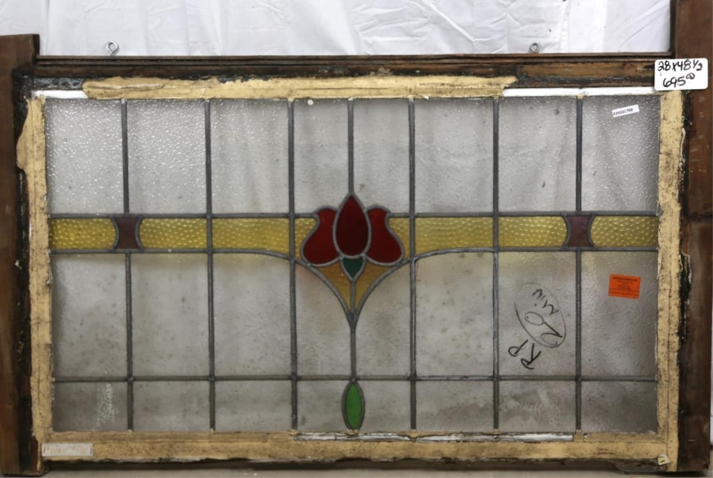 FRENCH ART NOUVEAU STAINED GLASS PANEL: French Art Nouveau stained glass panel with a red flower medallion and amber textured details. Approximate dimensions: h. 28", w. 48.5" Disclaimer: This is an online court ordered bankruptcy sale. Par