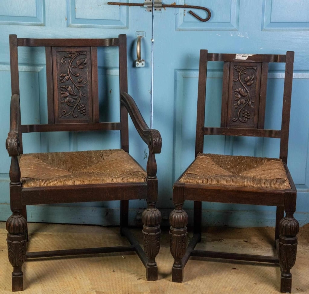 TWO 19TH C. FRENCH HAND CARVED CHAIRS: French, 19th century. Hand-carved chairs, with rush seats, stretcher base, and carved backs and legs. Approximate dimensions: armchair: h. 39", w. 24", d. 27" Disclaimer: This is an online court order