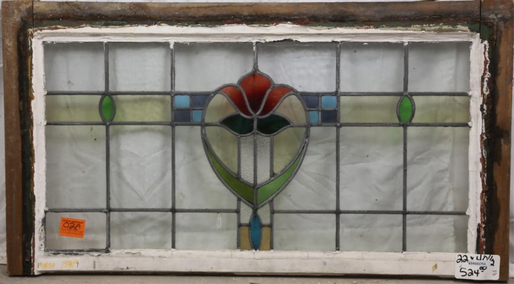 FRENCH ART NOUVEAU STAINED GLASS PANEL: French Art Nouveau stained glass panel with heart-shaped red flower medallion and blue and green accent details. Approximate dimensions: h. 22", w. 40.5" Disclaimer: This is an online court ordered ba