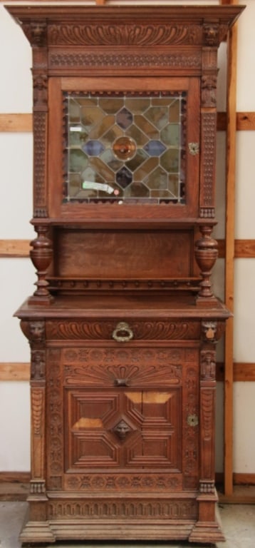 FRENCH RENAISSANCE REVIVAL STAINED GLASS BUFFET: French Renaissance Revival stained glass buffet with a stained glass door panel featuring amber jeweled detail and elaborate carving throughout Approximate dimensions: h. 89", w. 36", d. 20" Disclaime