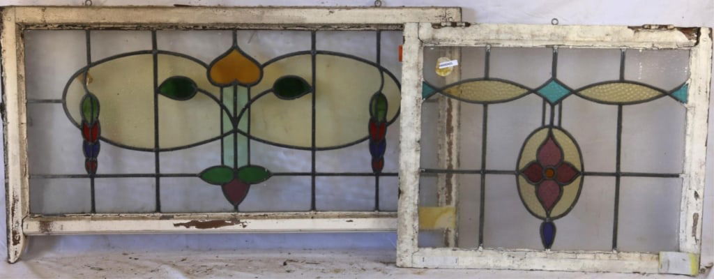 TWO CONTINENTAL STAINED GLASS PANELS: Two Continental stained glass panels with multicolored stained glass details. Approximate dimensions: h. 24", w. 42" Disclaimer: This is an online court ordered bankruptcy sale. Participating bidders