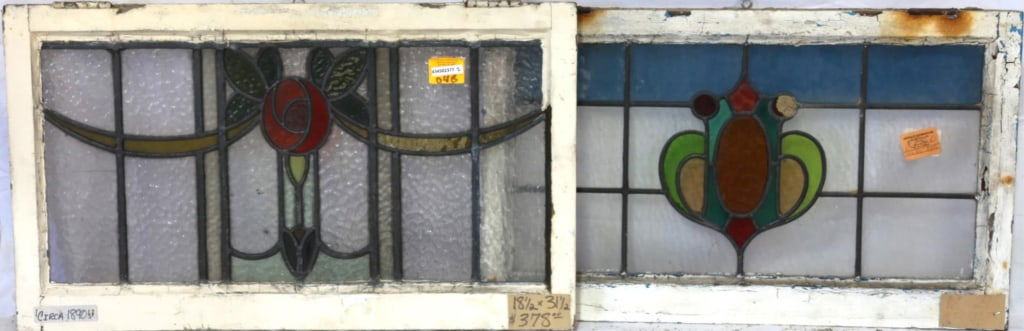 TWO ENGLISH STAINED GLASS PANELS: Two English stained glass panels, one with a floral medallion and garland motif, and the other with a shield-form medallion in multicolored stained glass. Approximate dimensions: h. 18.5", w. 31.5" Di