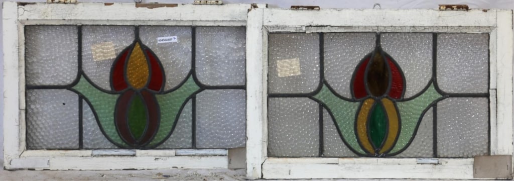 TWO ENGLISH STAINED GLASS PANELS: Two English stained glass panels with abstract medallions, one with wispy glass accents, both set within colorless leaded glass panels. Approximate dimensions: h. 15", w. 23.5" Disclaimer: This is an