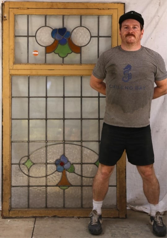 ANTIQUE CONTINENTAL STAINED GLASS PANEL: Antique Continental stained glass panel with floral medallions, wispy glass accents, and colorless leaded glass panels. Approximate dimensions: h. 70", w. 40" Disclaimer: This is an online court order