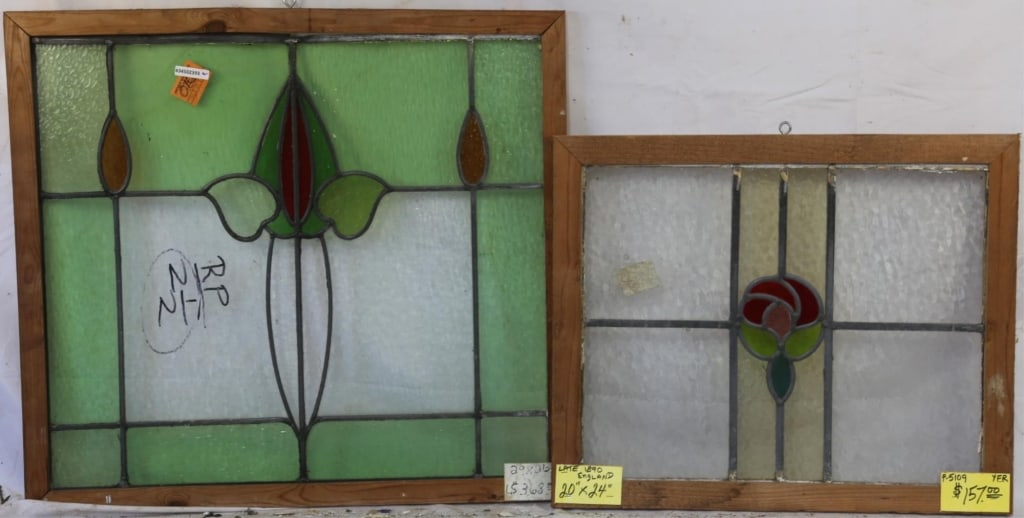 TWO ENGLISH STAINED GLASS PANELS: Two English stained glass panels, both adorned with abstract floral medallions in multicolored glass. Approximate dimensions: h. 27", w. 26" Disclaimer: This is an online court ordered bankruptcy sale