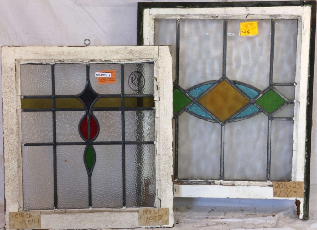 TWO CONTINENTAL STAINED GLASS PANELS: Two Continental stained glass panels with multicolored abstract stained glass medallions. Approximate dimensions: h. 23", w. 20.5" Disclaimer: This is an online court ordered bankruptcy sale. Particip