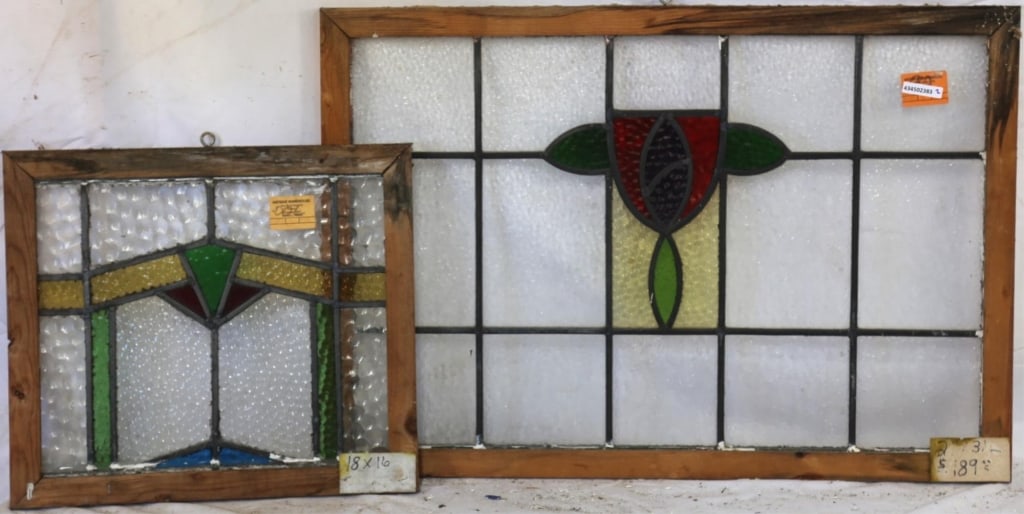 TWO CONTINENTAL STAINED GLASS PANELS: Two Continental stained glass panels, one with a geometric medallion, and the other with an abstract floral medallion. Approximate dimensions: h. 21", w. 31" Disclaimer: This is an online court ordere