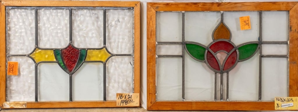 TWO CONTINETAL STAINED GLASS PANELS: Two Continental stained glass panels, one with a floral medallion and the other with a shield-shaped medallion. Approximate dimensions: h. 16", w. 21" Disclaimer: This is an online court ordered bankr