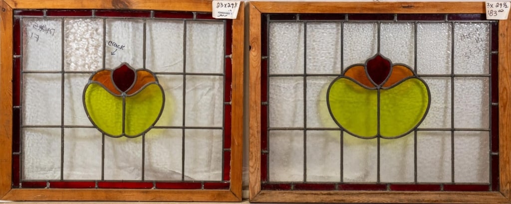 TWO FRENCH STAINED GLASS PANELS: Two French stained glass panels with a floral motif accented by dark red stained glass details. Approximate dimensions: h. 23", w. 29.5" Disclaimer: This is an online court ordered bankruptcy sale. Pa