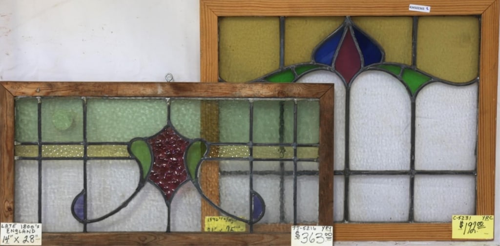 TWO ENGLISH STAINED GLASS PANELS: Two English stained glass panels with intricate multicolored glass details. Approximate dimensions: h. 21", w. 25" Disclaimer: This is an online court ordered bankruptcy sale. Participating bidders mu