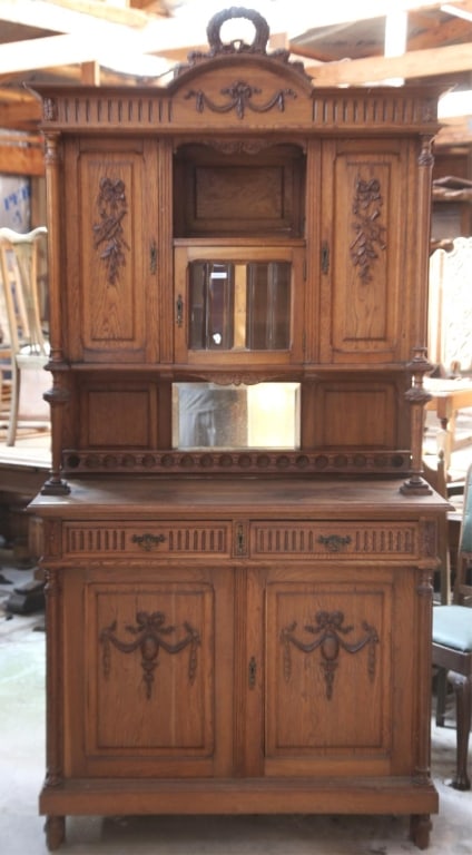 FRENCH ART NOUVEAU VITRINE BUFFET: French Art Nouveau vitrine buffet with a beveled mirror backsplash, beveled glass cabinet, carved supports and gallery, carved appliqués, and a wreath and garland pediment. Approximate dimensions: h.