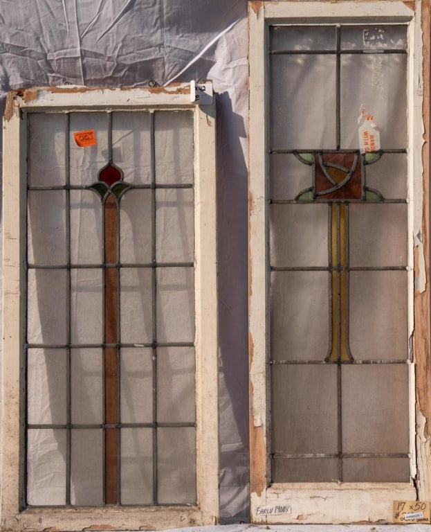 TWO ANTIQUE CONTINENTAL STAINED GLASS PANELS: Two antique Continental stained glass panels with floral motif central elements and colorless leaded glass panels. Approximate dimensions: h. 50", w. 17" Disclaimer: This is an online court ordered ba