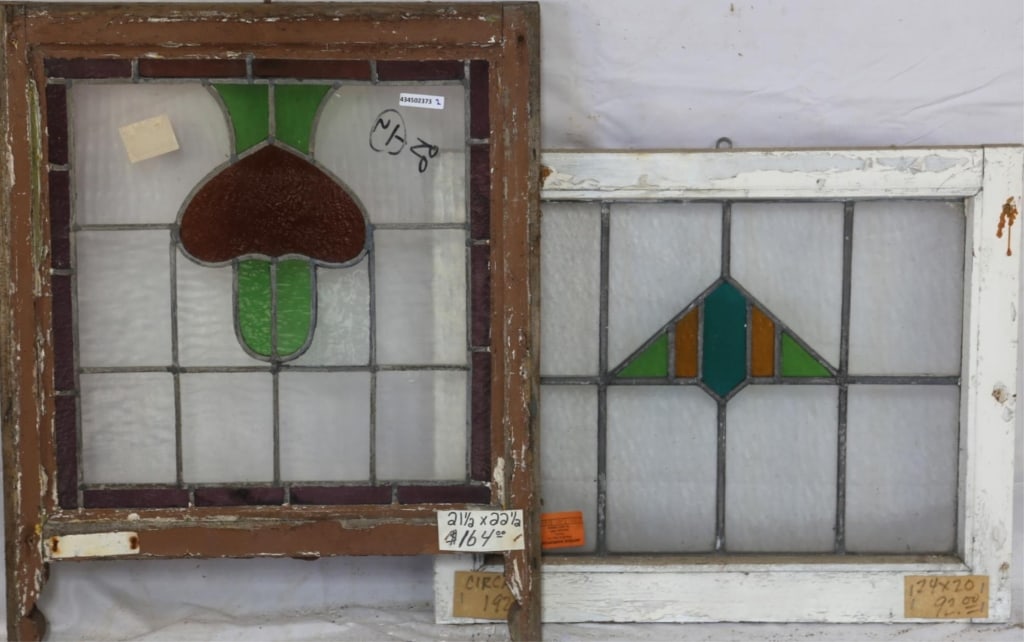 TWO CONTINENTAL STAINED GLASS PANELS: Two Continental stained glass panels with multicolored stained glass accents. Approximate dimensions: h. 21.5", w. 22.5" Disclaimer: This is an online court ordered bankruptcy sale. Participating bidd