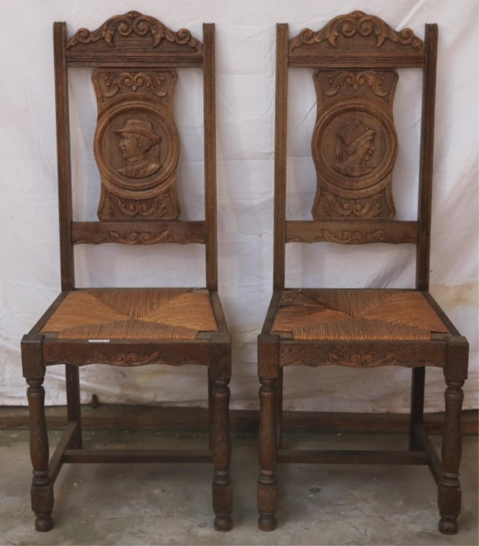 PAIR OF RENAISSANCE REVIVAL RUSH SEAT CHAIRS: Pair of Renaissance Revival rush seat chairs with a stretcher base, hand-carved portrait backs, and carved crests. Approximate dimensions: h. 43.5", w. 18", d. 18" Disclaimer: This is an online court 