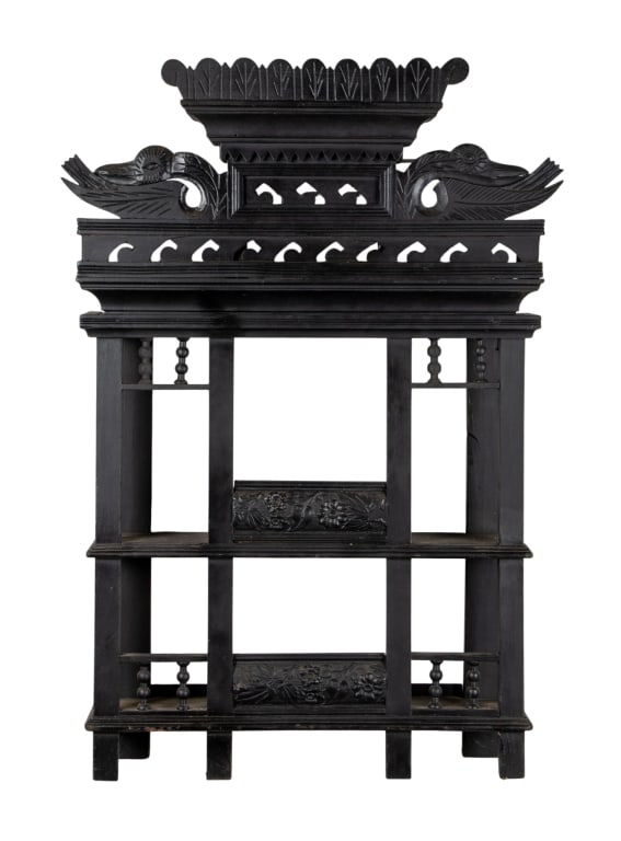 EASTLAKE STYLE EBONIZED WALL ETAGERE: Eastlake style ebonized wall etagere with carved crown with bird motif and carved galleries. Approximate dimensions: h. 42.5", w. 27", d. 7" Disclaimer: Participating bidders must have a credit card