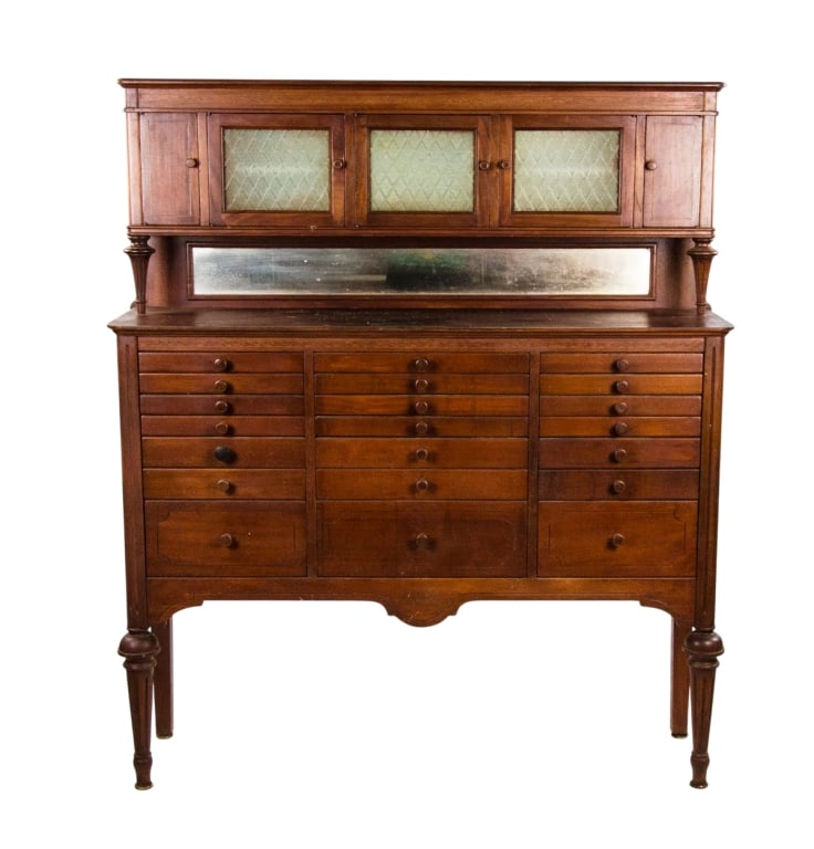 EARLY 20TH C. WOODEN DENTAL CABINET: Early 20th century. Wooden dental cabinet with 21 drawers and glass doors. Approximate dimensions: h. 58", w. 49.5", d. 14" Disclaimer: Participating bidders must have a credit card on file with LiveA