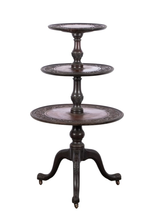 EARLY 20TH C. GEORGE III STYLE CARVED MAHOGANY THR: Early 20th century George III style carved mahogany three-tier dumbwaiter with carved Gaelic style foliate borders, turned pole center, and carved cabriole leg pedestal base with porcelain casters.
