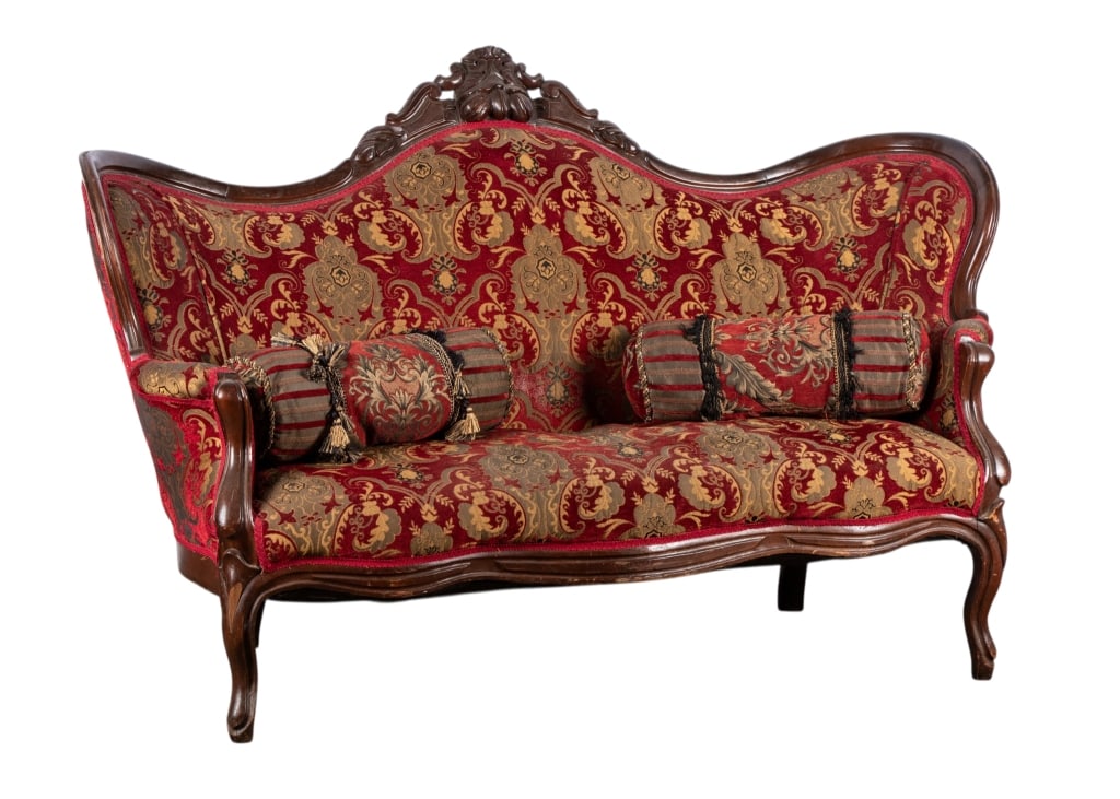 EARLY 20TH CENTURY VICTORIAN PARLOR SOFA: Early 20th century. Victorian parlor sofa with carved apron, two pillows, and carved crest. Approximate dimensions: h. 40", w. 64", d. 26" Disclaimer: Participating bidders must have a credit card on