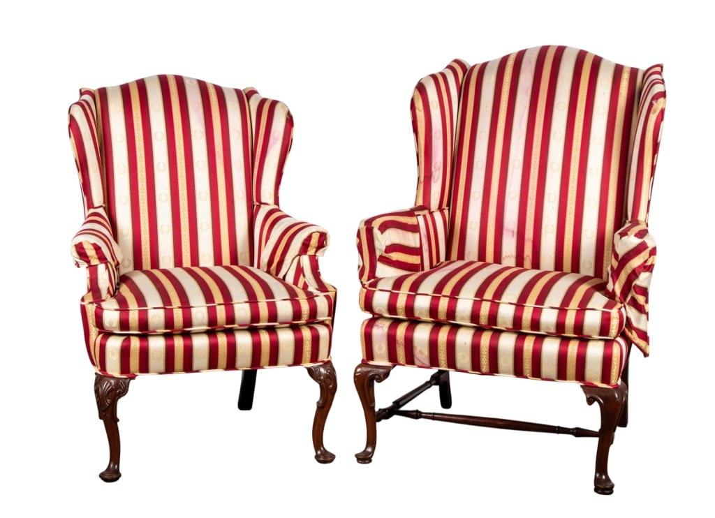NEAR PAIR, QUEEN ANNE STYLE WINGBACK ARMCHAIRS: Near pair, Queen Anne style wingback armchairs with stretcher base, carved legs, and striped upholstery. Approximate dimensions: h. 45", w. 34", d. 21" Disclaimer: Participating bidders must have a