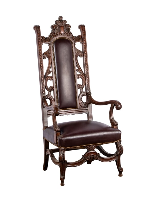 RENAISSANCE STYLE CARVED ARMCHAIR: Renaissance style carved armchair with nailhead trim accents, stretcher base, and carved details throughout. Approximate dimensions: h. 58", w. 21", d. 21" Disclaimer: Participating bidders must have