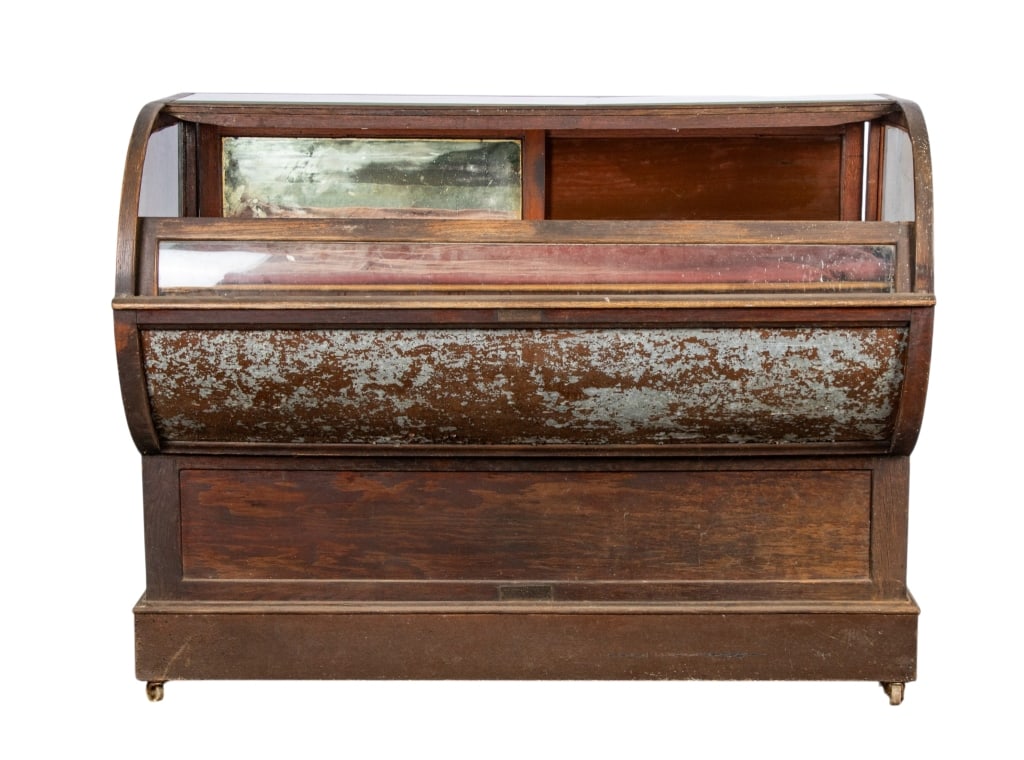 AMERICAN MERCANTILE STORE DISPLAY CASE: American mercantile store display case with mirrored side and curved glass. Approximate dimensions: h. 45", w. 57.5", d. 30" Disclaimer: Participating bidders must have a credit card on file with Live