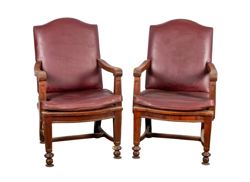 PAIR OF VINTAGE LEATHER OFFICE CHAIRS: Pair of vintage leather office chairs with stretcher base, turned feet, carved arms, and oxblood leather upholstery. Approximate dimensions: h. 42", w. 25.5", d. 28" Disclaimer: Participating bidders 