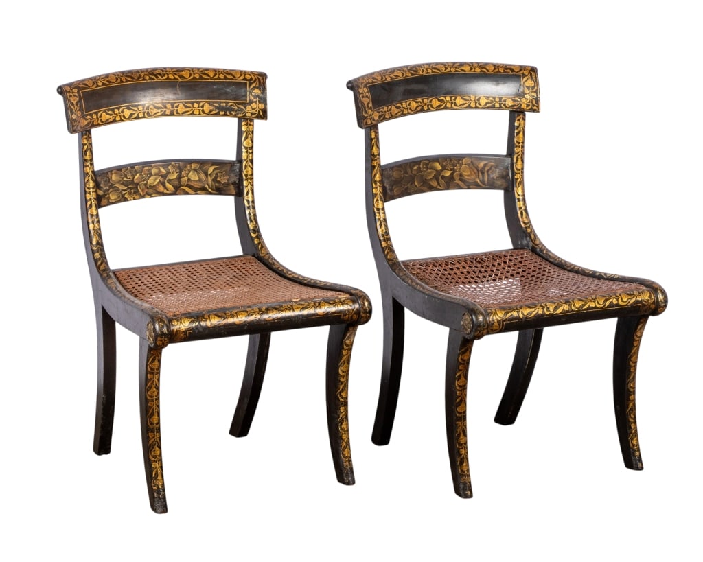 PAIR OF REGENCY WOOD & PARCEL GILT SIDE CHAIRS: Pair of Regency wood and parcel gilt side chairs with cane seats and floral motif gilt details throughout. Approximate dimensions: h. 30.5", w. 17.5", d. 17" Disclaimer: Participating bidders must hav