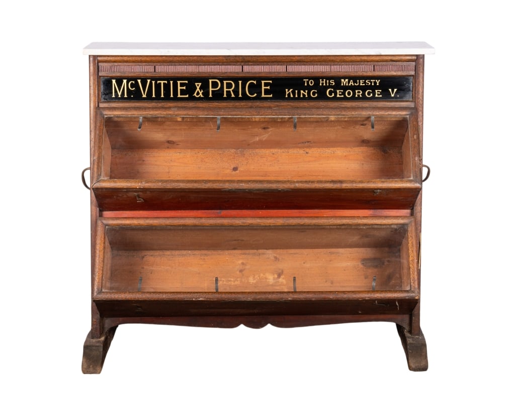 MCVITIE & PRICE STOREFRONT DISPLAY: McVitie & Price storefront display (Thomas Gillie & Son) for baked goods with marble top and two glass compartments. Approximate dimensions: h. 39", w. 43", d. 18.5" Disclaimer: Participating bidders